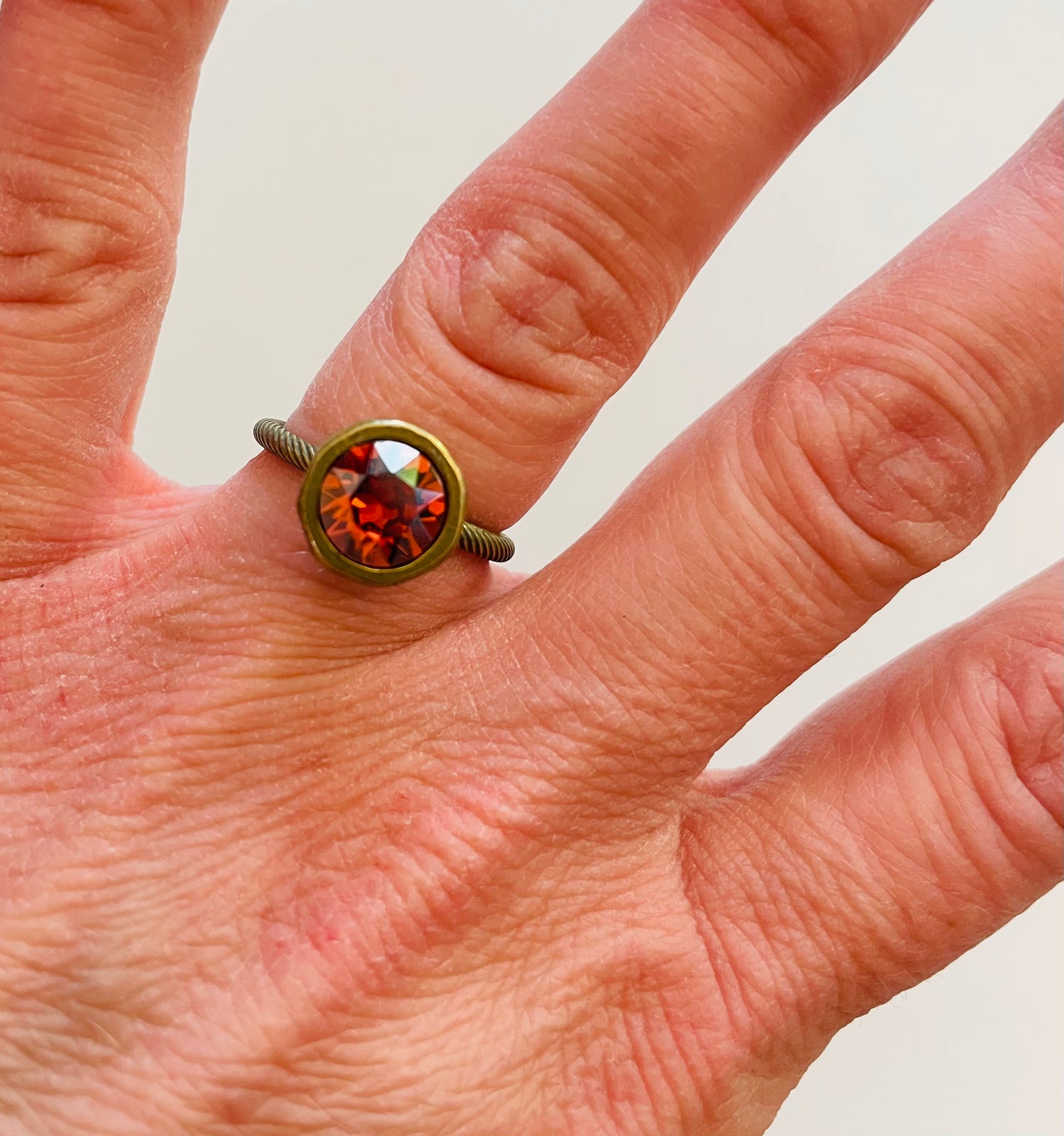 Simple Solitaire Ring featuring Padparadscha Luster